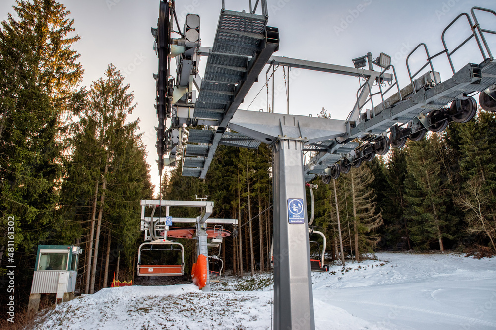 Fototapeta premium Ski resort image with empty chair lift. Ski-lift