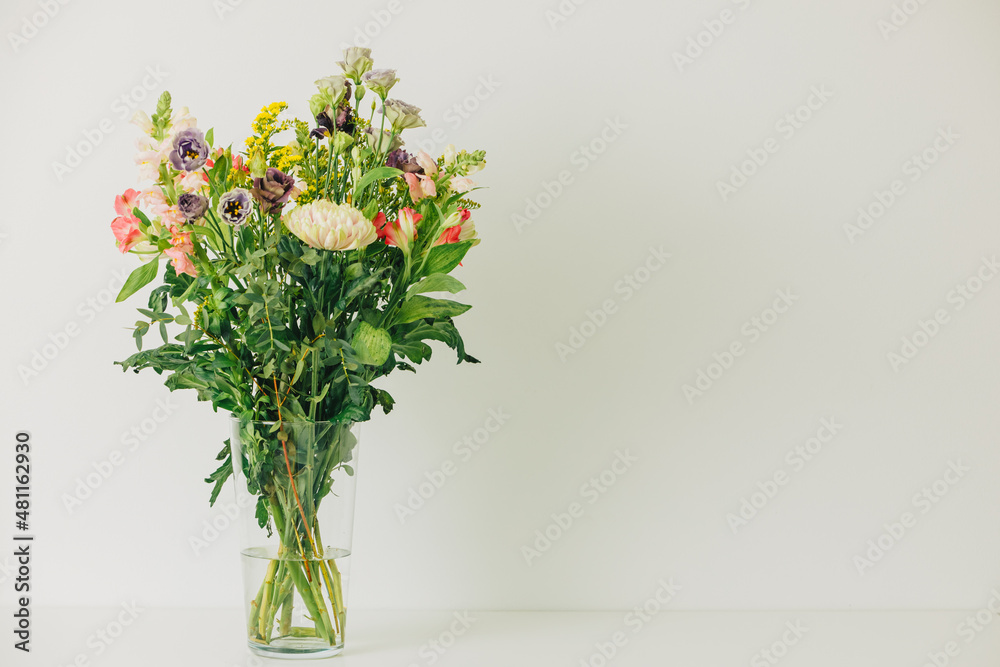 Beautiful bouquet of flowers in a vase. Bouquet of chrysanthemum, alstroemeria, goldenrod, snapdragon, lisianthus and eucalyptus parvifolia. bouquet of flowers on white background. Beautiful bouquet of flowers in a vase. Bouquet of chrysanthemum, alstroemeria, goldenrod, snapdragon, lisianthus and eucalyptus parvifolia. bouquet of flowers on white background.