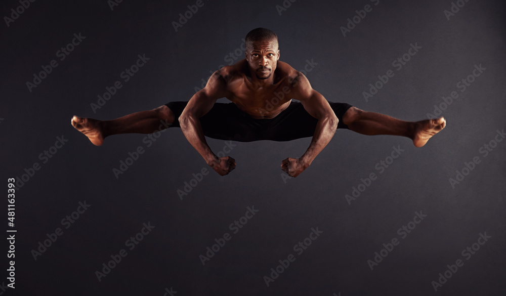 Perfection attained. Male dancer performing the splits in mid-air. Perfection attained. Male dancer performing the splits in mid-air.