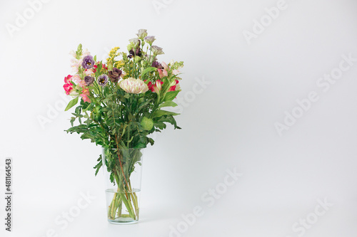 Beautiful bouquet of flowers in a vase. Bouquet of chrysanthemum, alstroemeria, goldenrod, snapdragon, lisianthus and eucalyptus parvifolia. bouquet of flowers on white background. 