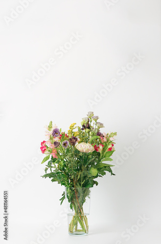 Beautiful bouquet of flowers in a vase. Bouquet of chrysanthemum, alstroemeria, goldenrod, snapdragon, lisianthus and eucalyptus parvifolia. bouquet of flowers on white background. 