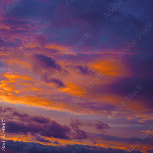 Purple orange sunset. Evening sky with clouds. Beautiful colorful sky background with space for design. Magic fantasy skies.