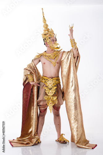 Full length portrait of 20s asian man wear gold leaf foil and golden dress of National costume