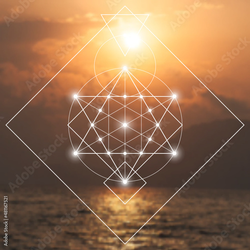 Merkaba sacred geometry spiritual new age futuristic illustration with interlocking circles, triangles and glowing particles in front of blurry natural photographic background