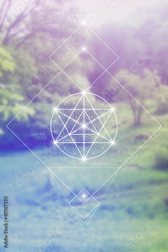 Merkaba sacred geometry spiritual new age futuristic illustration with interlocking circles, triangles and glowing particles in front of blurry natural photographic background