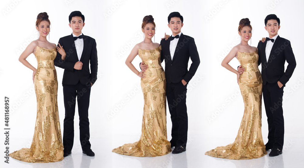 Two couple Full length of man in black suit tie and woman in gold long ...
