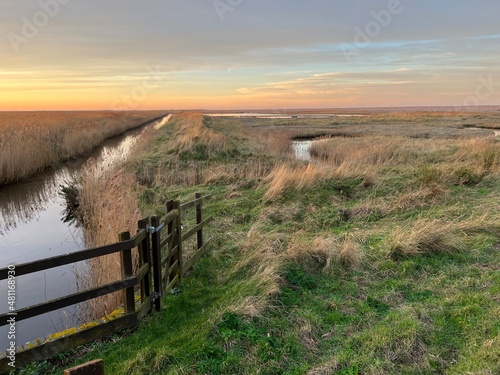 Fotomurale Sunset landscape of Cley next the sea beautiful marshland nature reserve in Norf