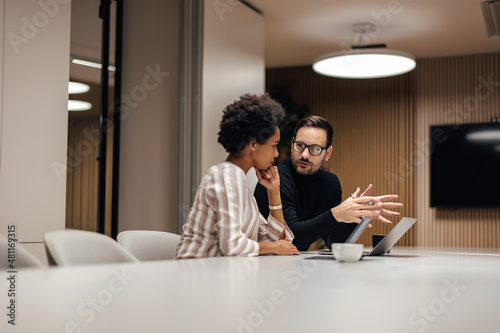 Foto Serious business partners, figuring out their next step in the future business