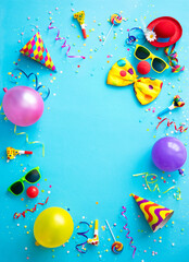 Colorful carnival or birthday party background with streamers, confetti and funny faces
