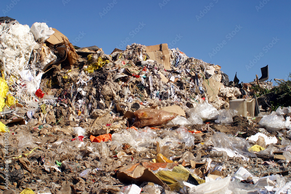 Waste piled up in a landfill site, showing a lack of recycling.