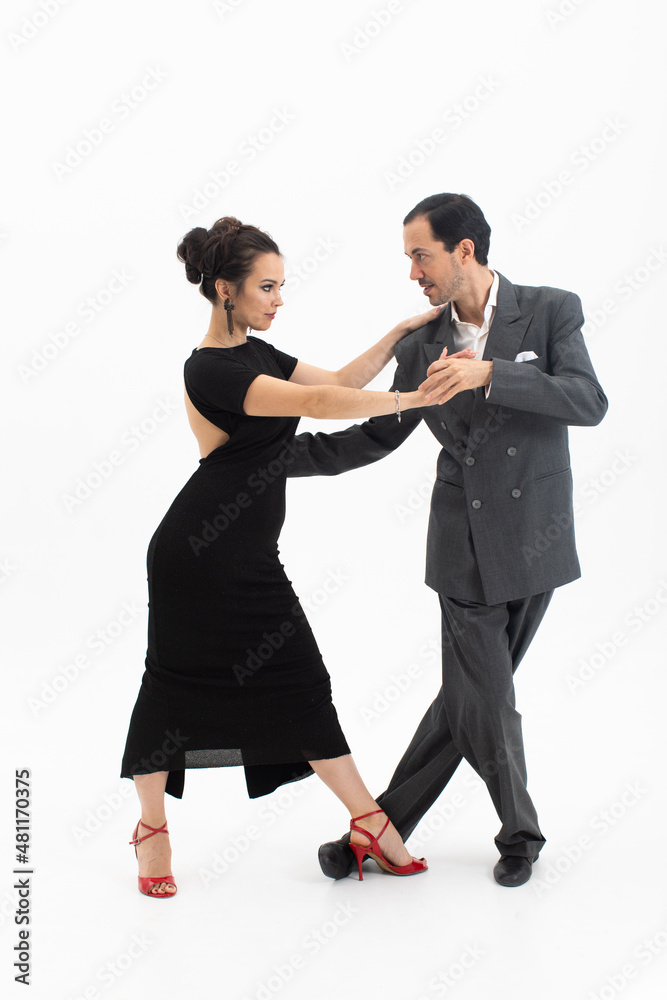 Couple in elegant clothes dancing tango on white background Couple in elegant clothes dancing tango on white background