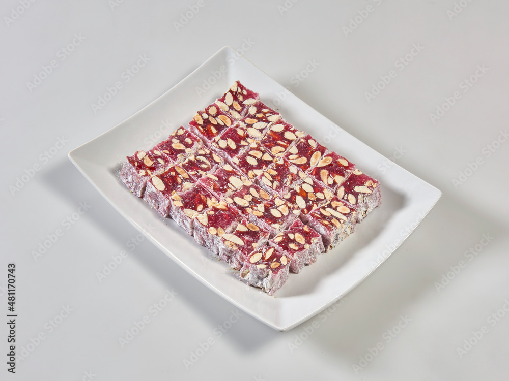 Turkish delight is in the plate, white isolated background.