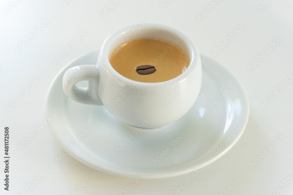 a small coffee in a white cup a small coffee in a white cup