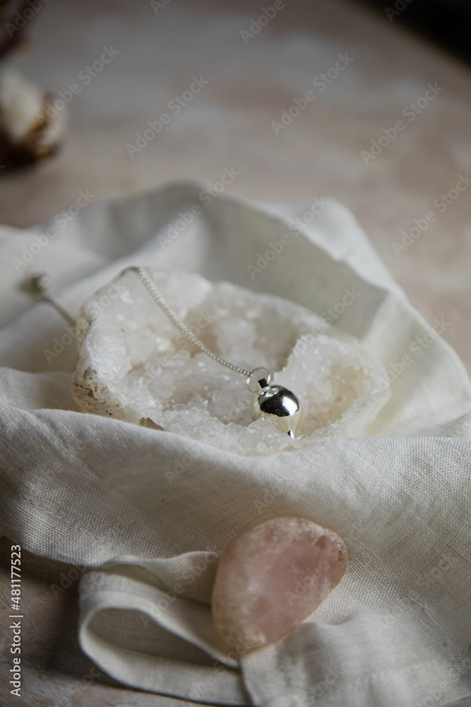 silver divination pendulum on a quartz geod silver divination pendulum on a quartz geod