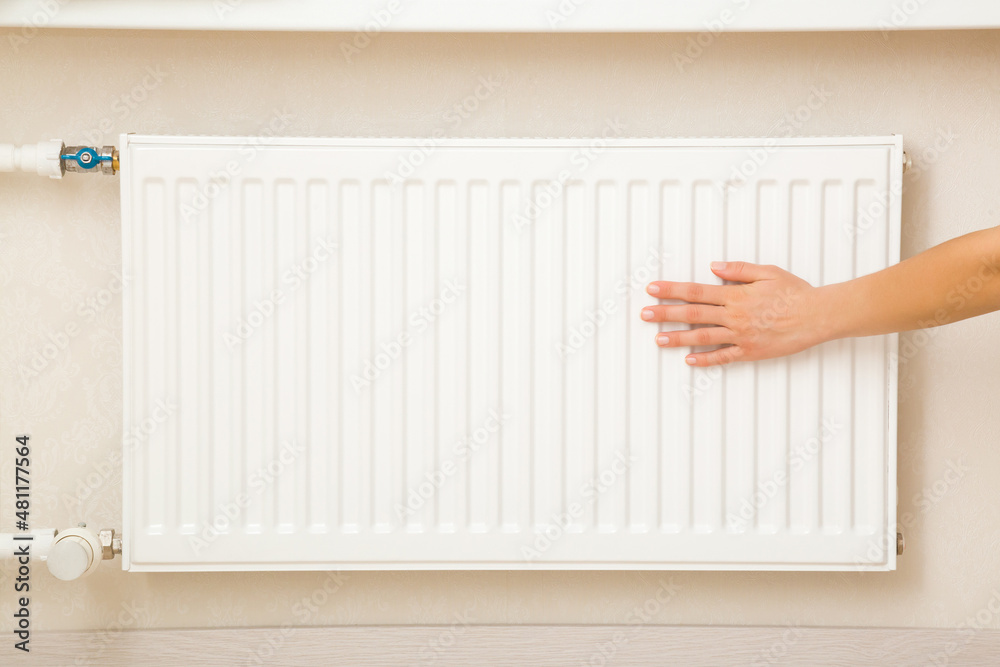 custom made wallpaper toronto digitalYoung adult woman hand touching white heater and checking warmth in room. Heating season. Closeup. Front view.