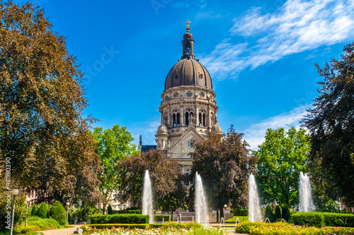Beautiful view of the famous Christuskirche (Christ Church), a Protestant church in Mainz, Germany on a sunny day with a blue sky. In front is a park with the fountain called Hans-Klenk-Brunnen. photo