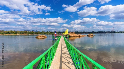 A bridge leading to the Buddha's Footprint in the middle of the Mekong River in Tha Uthen District, Nakhon Phanom Province, Thailand. photo