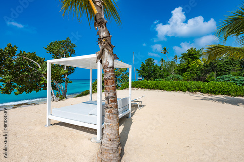 white bed on the sandy beach of the sea