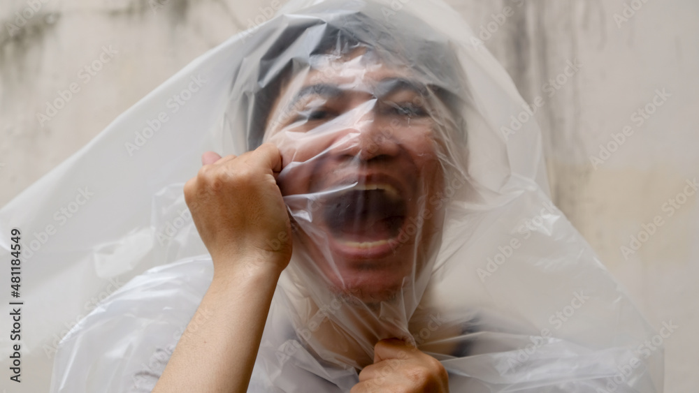 Young Man with a black transparent bag on his head. suffocate. face in a plastic  bag, strangulation. environmental pollution Photos | Adobe Stock