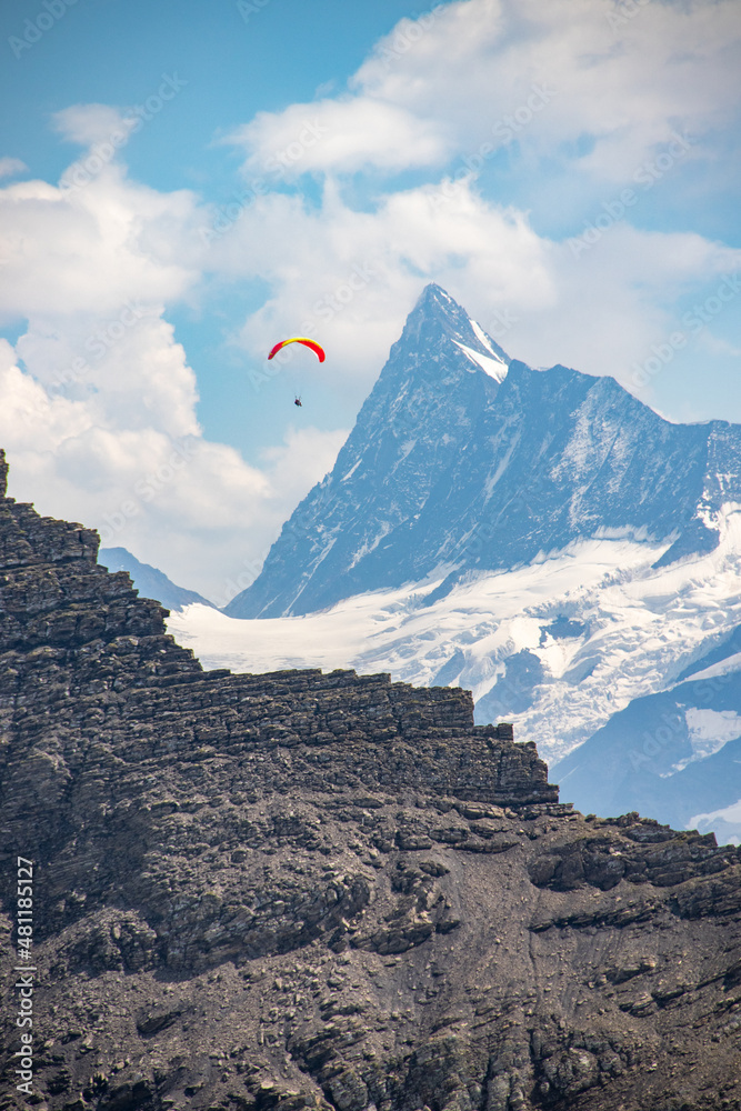 Paraglider between mountain peaks