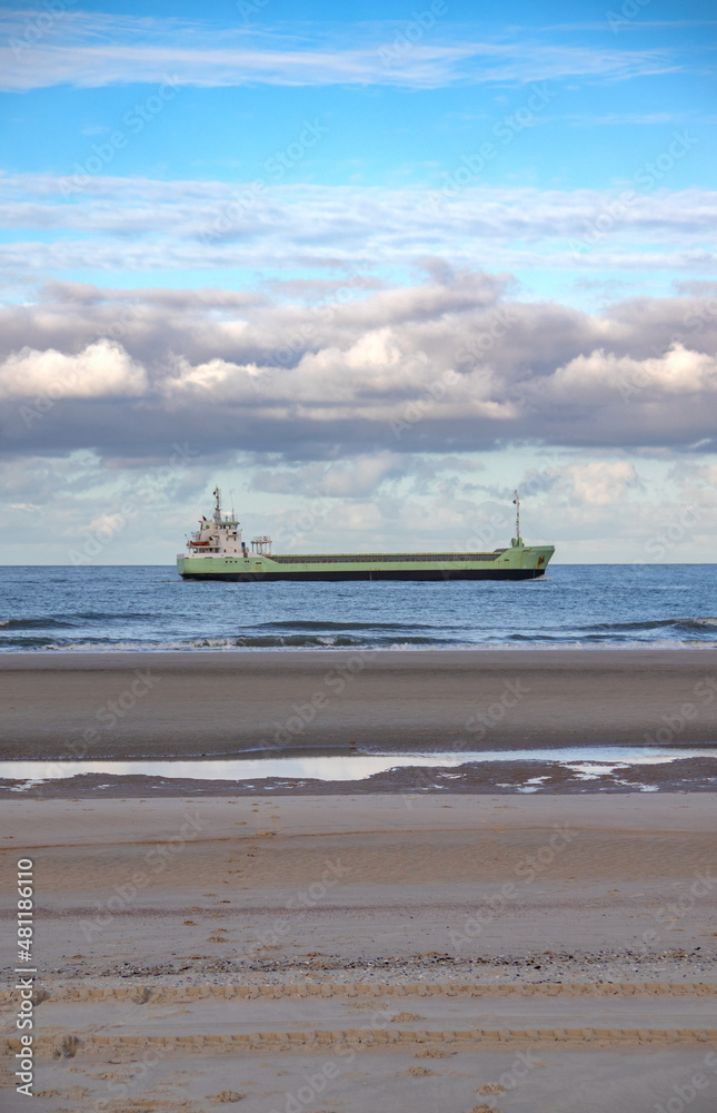 Huge ship passing the beach