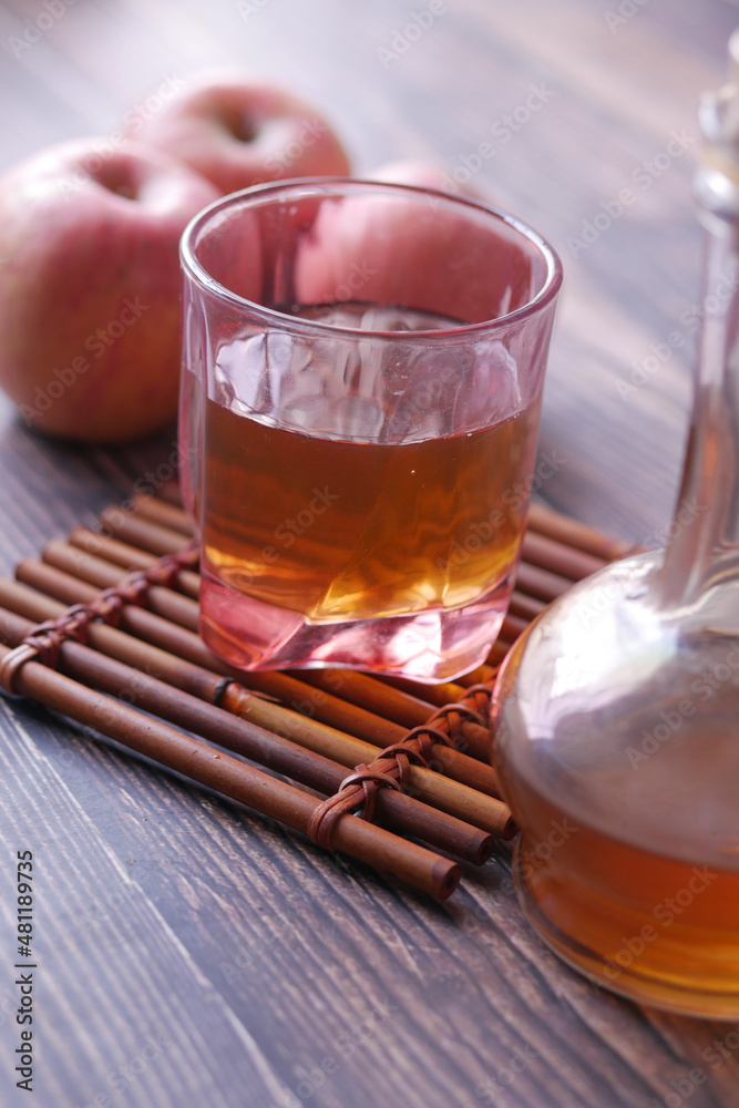 apple vinegar in glass bottle with fresh green apple on table apple vinegar in glass bottle with fresh green apple on table