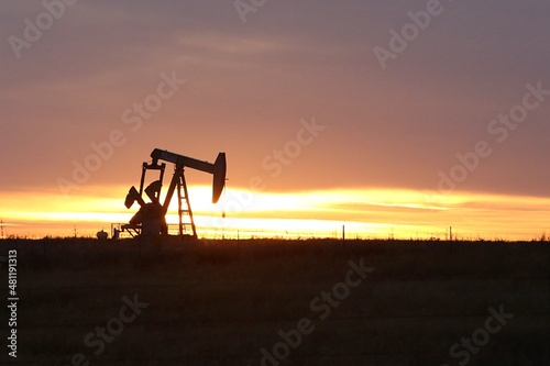 oil pump jack at sunset