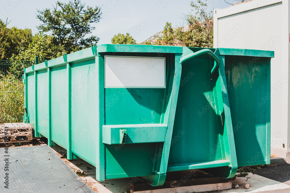 Large waste container at local sorting station - obrazy, fototapety, plakaty 