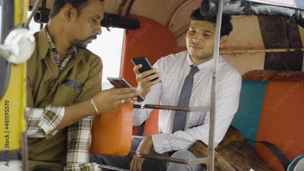 Auto rickshaw or cab passenger paying money by scanning qr code on mobile phone - concept of digital or online contactless payment and secure wireless transaction