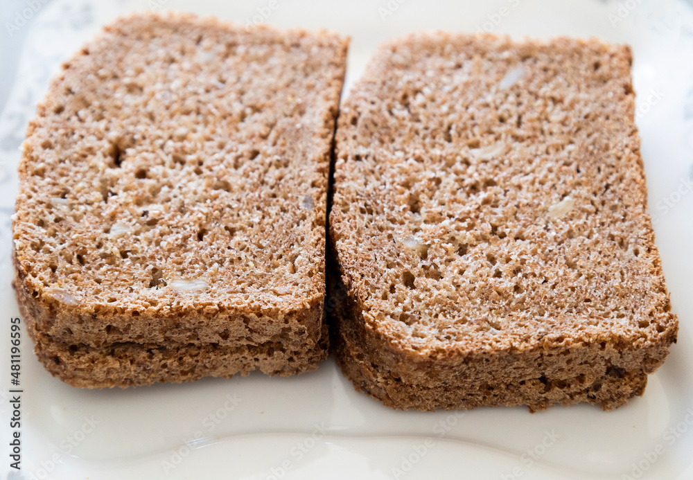 wheat bread slices close up on white background