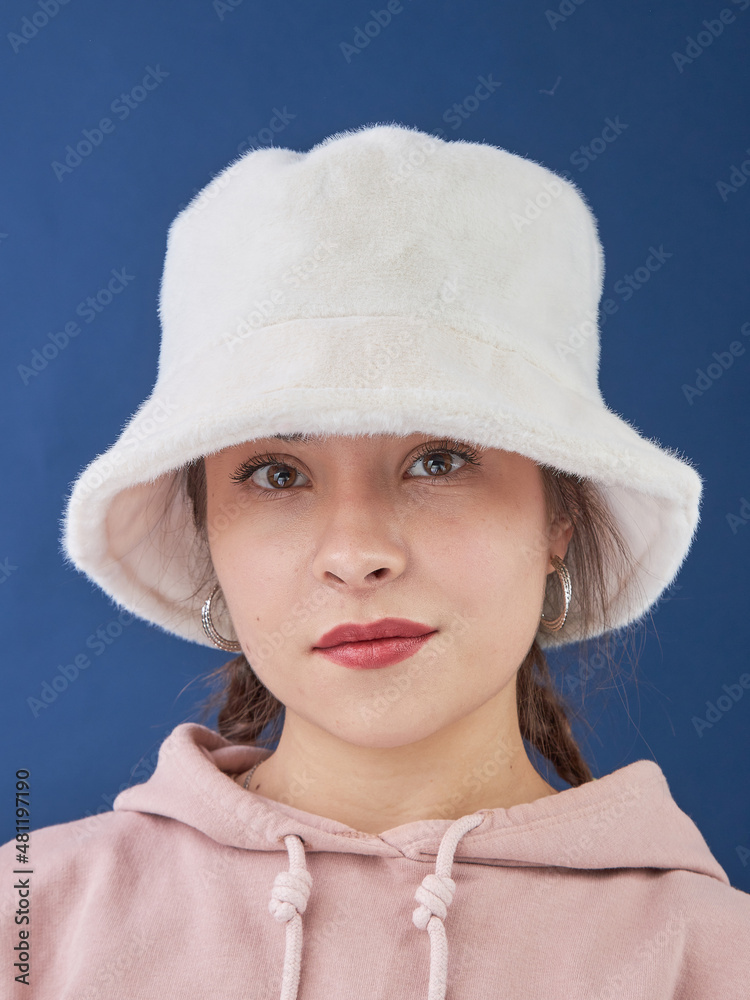young lady in a panama hat on a blue background. young lady in a panama hat on a blue background.