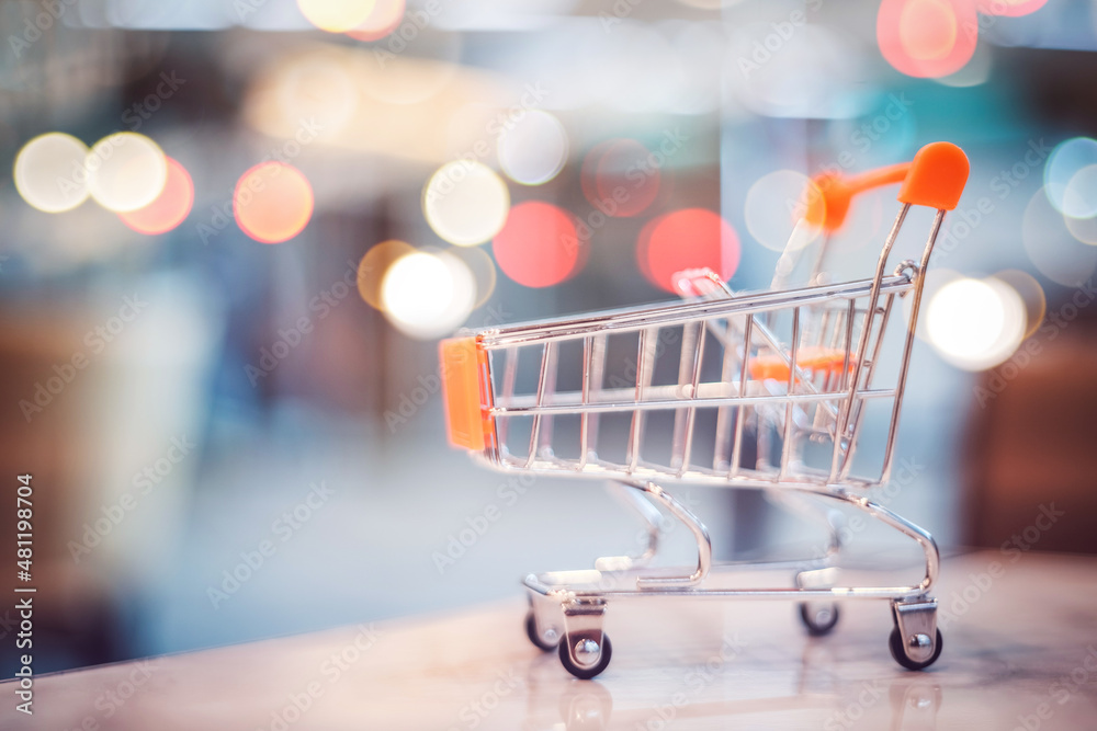 Small cart model with colorful bokeh abstract background. Business service and shopping concept. Small cart model with colorful bokeh abstract background. Business service and shopping concept.
