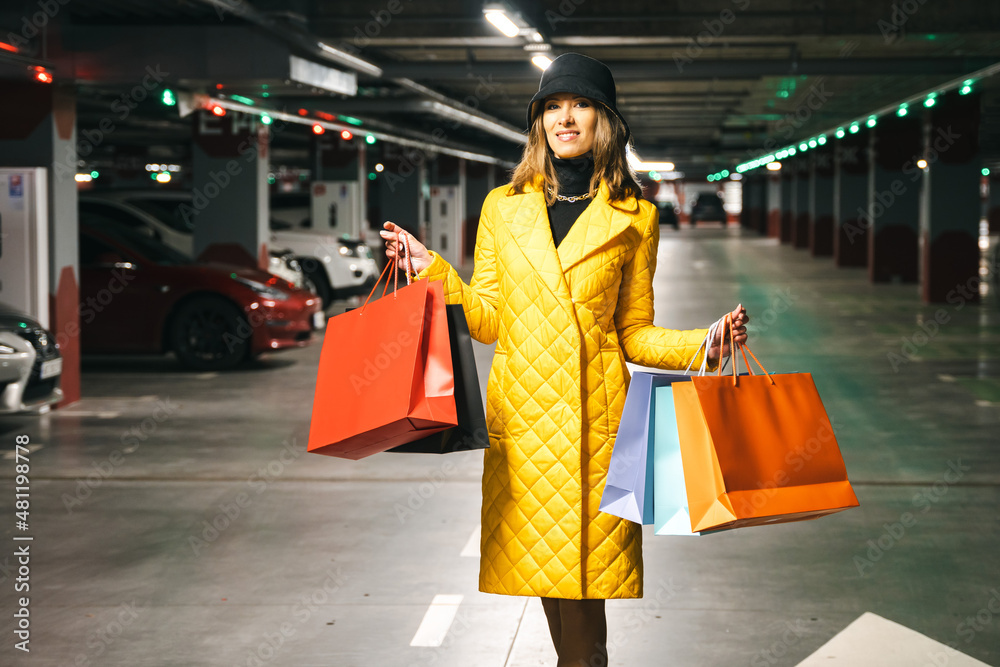 Woman after shopping going to her car at the parking lot. Woman after shopping going to her car at the parking lot.