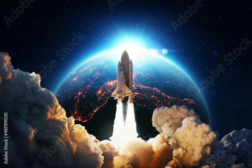 New space rocket lift off. Space shuttle with smoke and blast takes off into space on a background of blue planet earth with amazing sunset. Successful start of a space mission. Travel to Mars