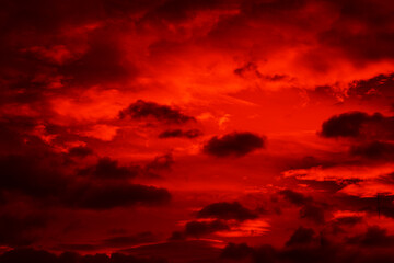 Bright red sunset. Dramatic evening sky with clouds. Fiery skies with space for design. Magic fantasy sky. War, battle, terror, world apocalypse, horror concept.