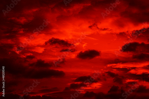 Fototapeta Naklejka Na Ścianę i Meble -  Bright red sunset. Dramatic evening sky with clouds. Fiery skies with space for design. Magic fantasy sky. War, battle, terror, world apocalypse, horror concept.