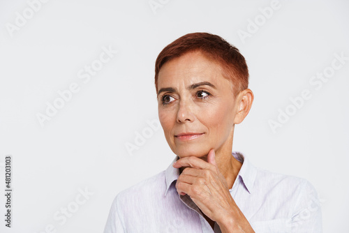 Ginger senior woman with short hair posing and looking aside