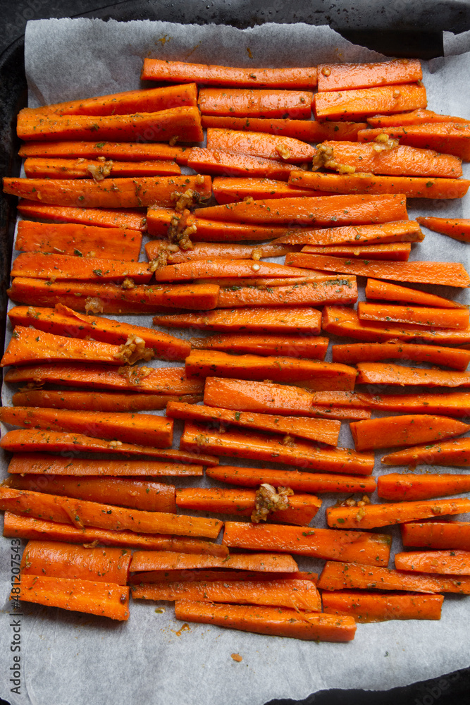 Sliced carrots with garlic and herb, ready to bake. Vegan food