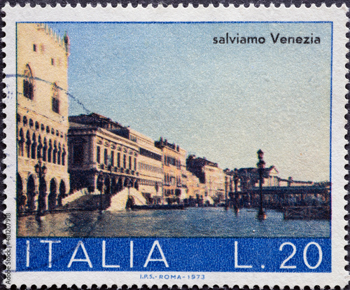 Italy - circa 1973: a postage stamp from Italy showing the Riva degli Schiavoni with high water in Venice photo