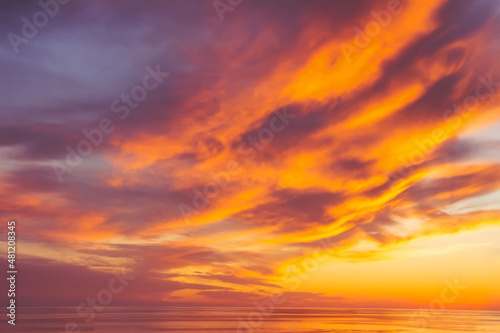 Beautiful sunset cloudy sky from aerial view  in the distance the water surface of the sea.