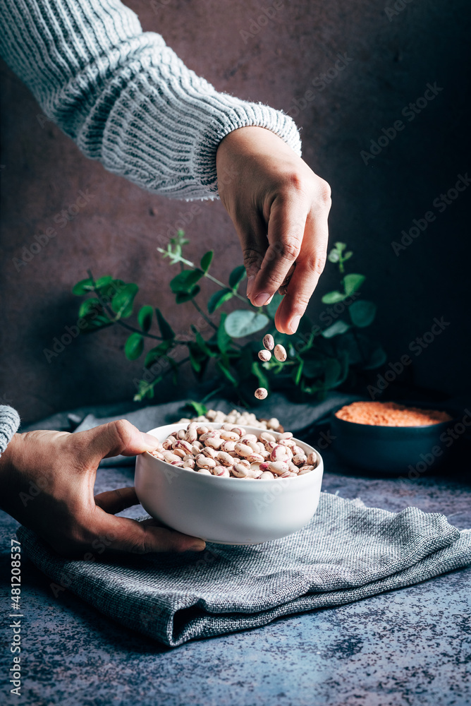 Anonymous person pouring chickpeas Anonymous person pouring chickpeas