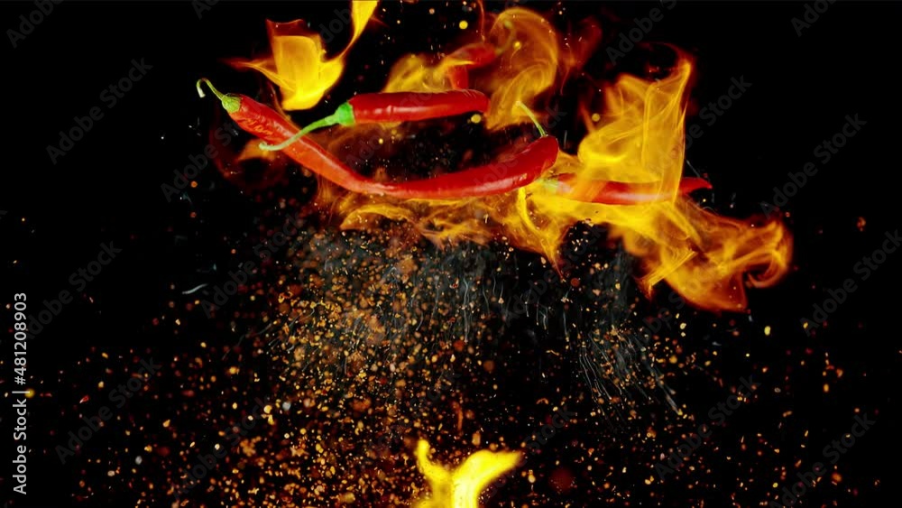 Red Chili Peppers and Chilli Powder Spice Flying up in Flames in Slow Motion 1000fps