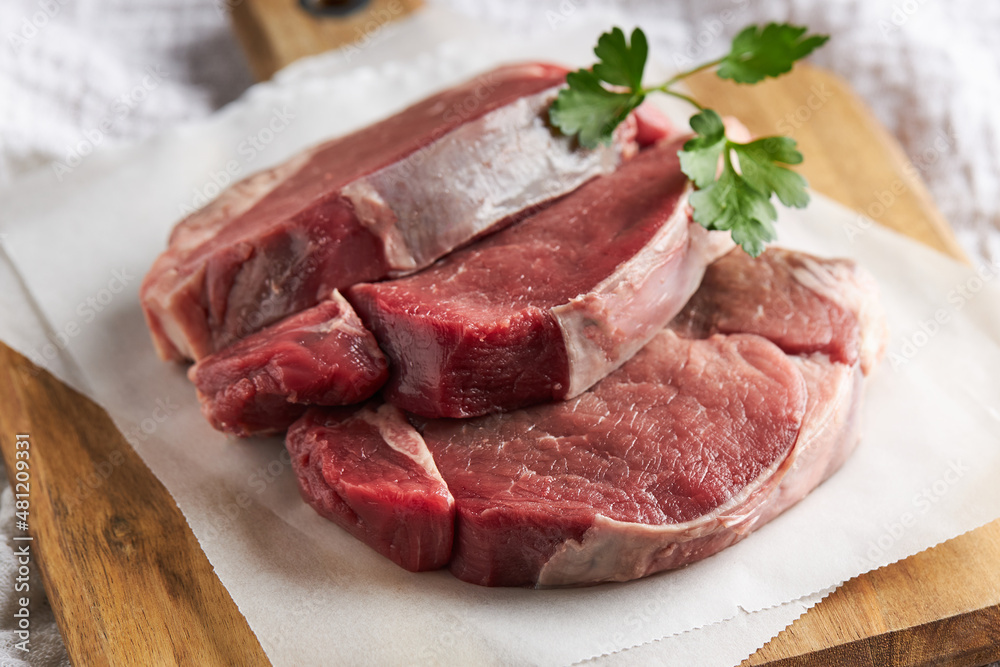 Raw beef sirloins on cutting board Raw beef sirloins on cutting board