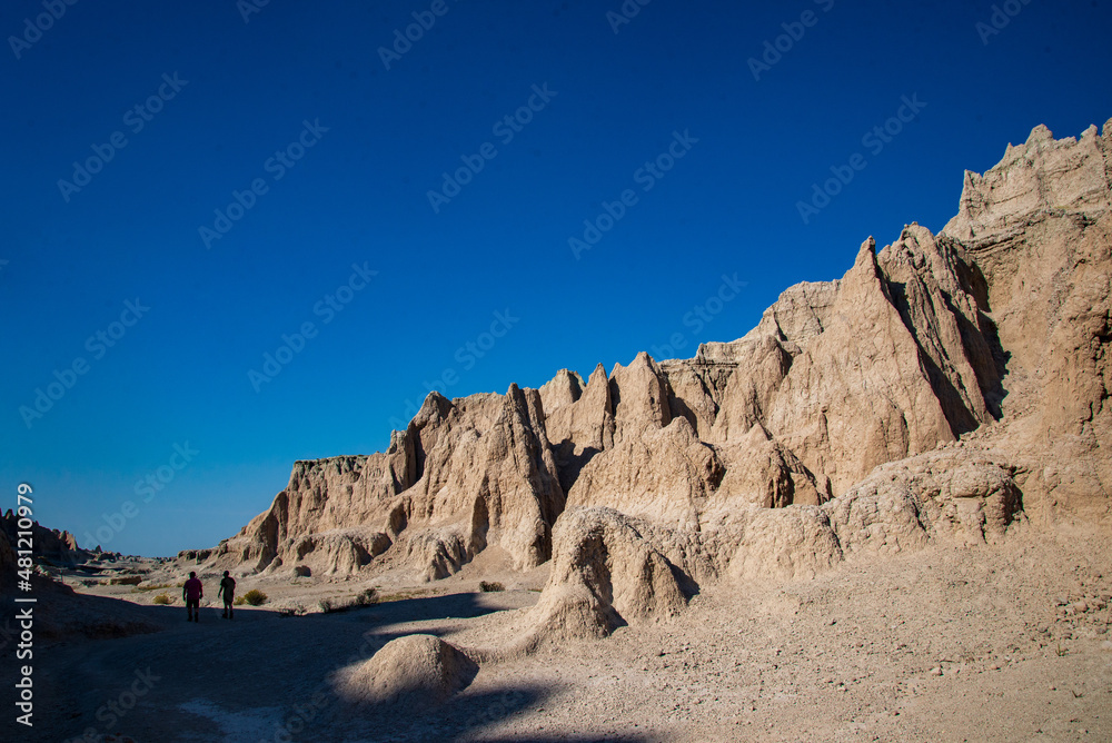 Hikers explore Notch Trail in Badlands National Park, South Dakota.