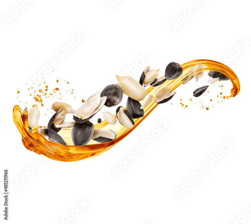 Splashes of oil with peeled sunflower seeds isolated on white background
