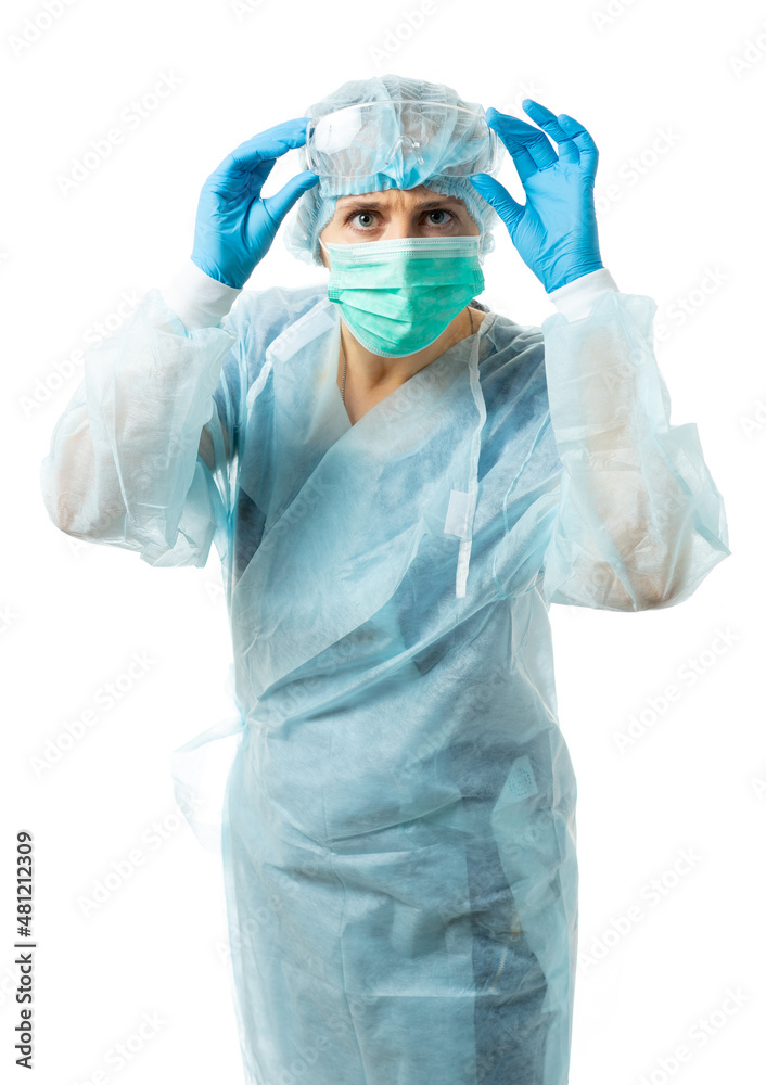 the nurse in sterile disposable clothes and a mask carefully looks at us, raised her glasses over her eyes. the doctor is not satisfied, frowns. isolated the nurse in sterile disposable clothes and a mask carefully looks at us, raised her glasses over her eyes. the doctor is not satisfied, frowns. isolated