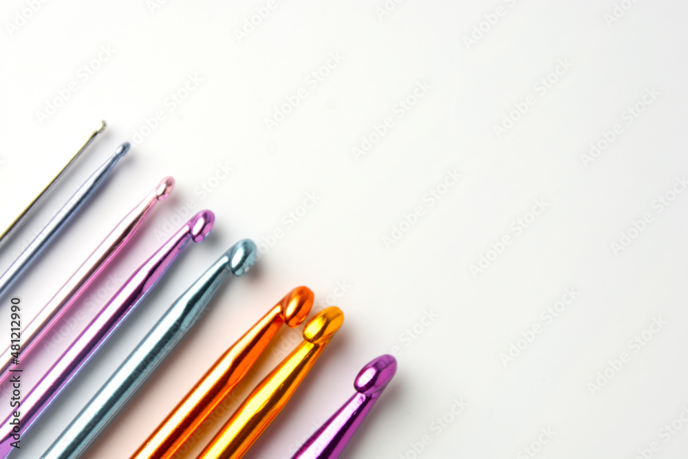 Fototapeta premium Crochet hooks set in special case, on white background. Craf and knit concept.