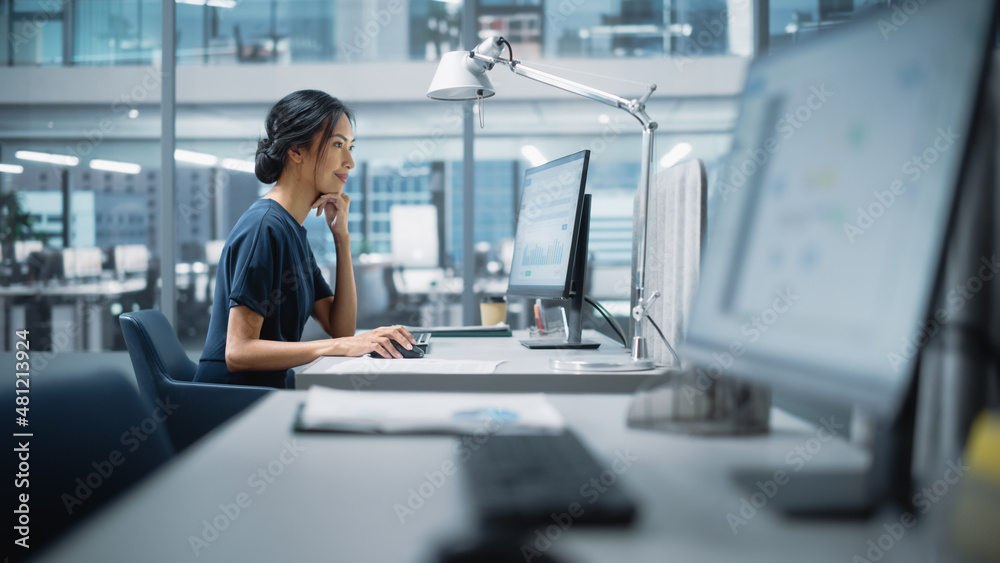 In Big Diverse Corporate Office: Portrait of Beautiful Asian Manager Using Desktop Computer, Businesswoman Managing Company Operations, Analysing Statistics, Commerce Data, Marketing Plans. In Big Diverse Corporate Office: Portrait of Beautiful Asian Manager Using Desktop Computer, Businesswoman Managing Company Operations, Analysing Statistics, Commerce Data, Marketing Plans.