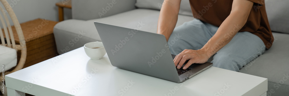 Work at home young asian man working on laptop computer while sitting at home Morning lifestyle Work at home young asian man working on laptop computer while sitting at home Morning lifestyle