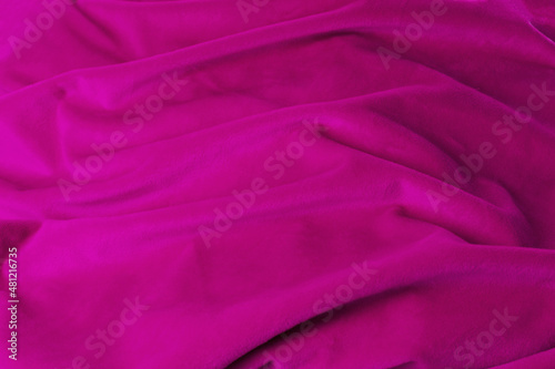 Fotografija Texture pink fabric top view. Pink fuchsia soft pleated fabric